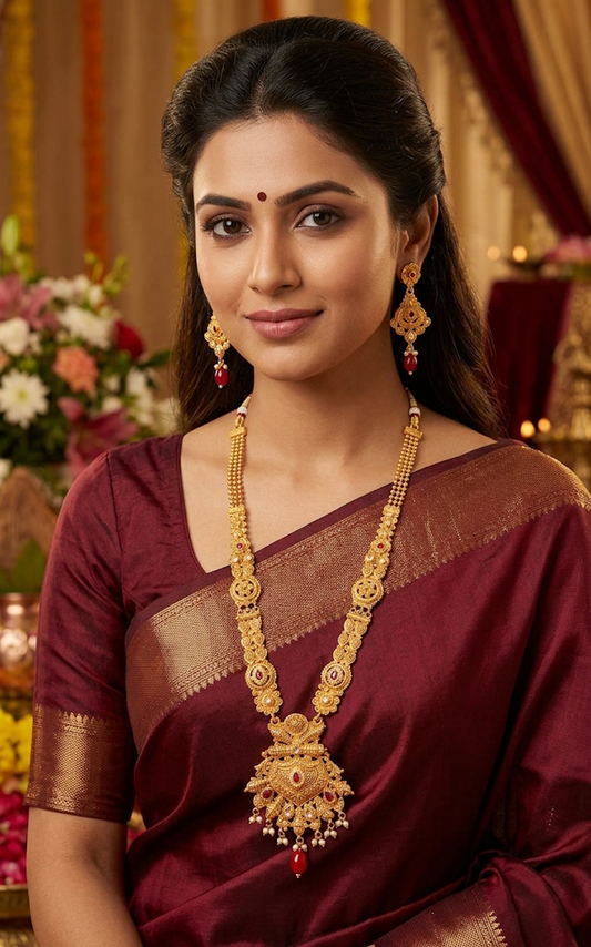 Traditional Gold Temple Jewelry Set: Long Haram Necklace and Matching Jhumka Earrings with Red Stone Accents and Pearl Drops